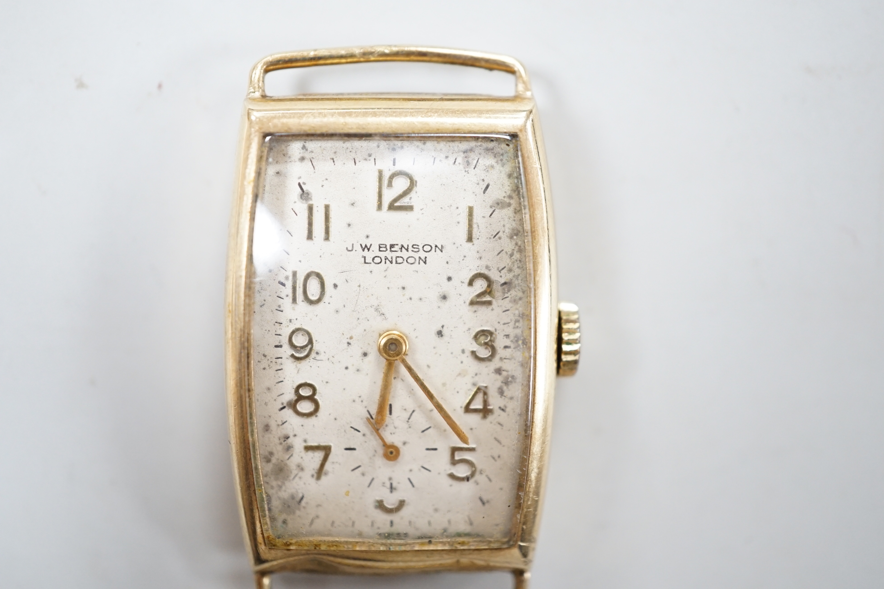 A gentleman's early 1950's 9ct gold J.W. Benson manual wind curved rectangular wrist watch, with Arabic dial and subsidiary seconds, case diameter 22mm, gross weight 16.3 grams, no strap.